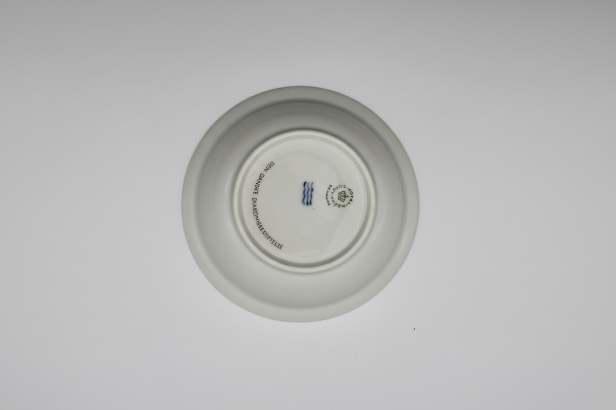 Royal Copenhagen plate underside showing crown logo, three waves, and DENMARK mark