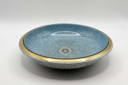 Crackle glaze ceramic dish with brass rim, overhead view showing blue-grey interior